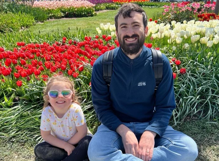 Elliot sitting in park with daughter