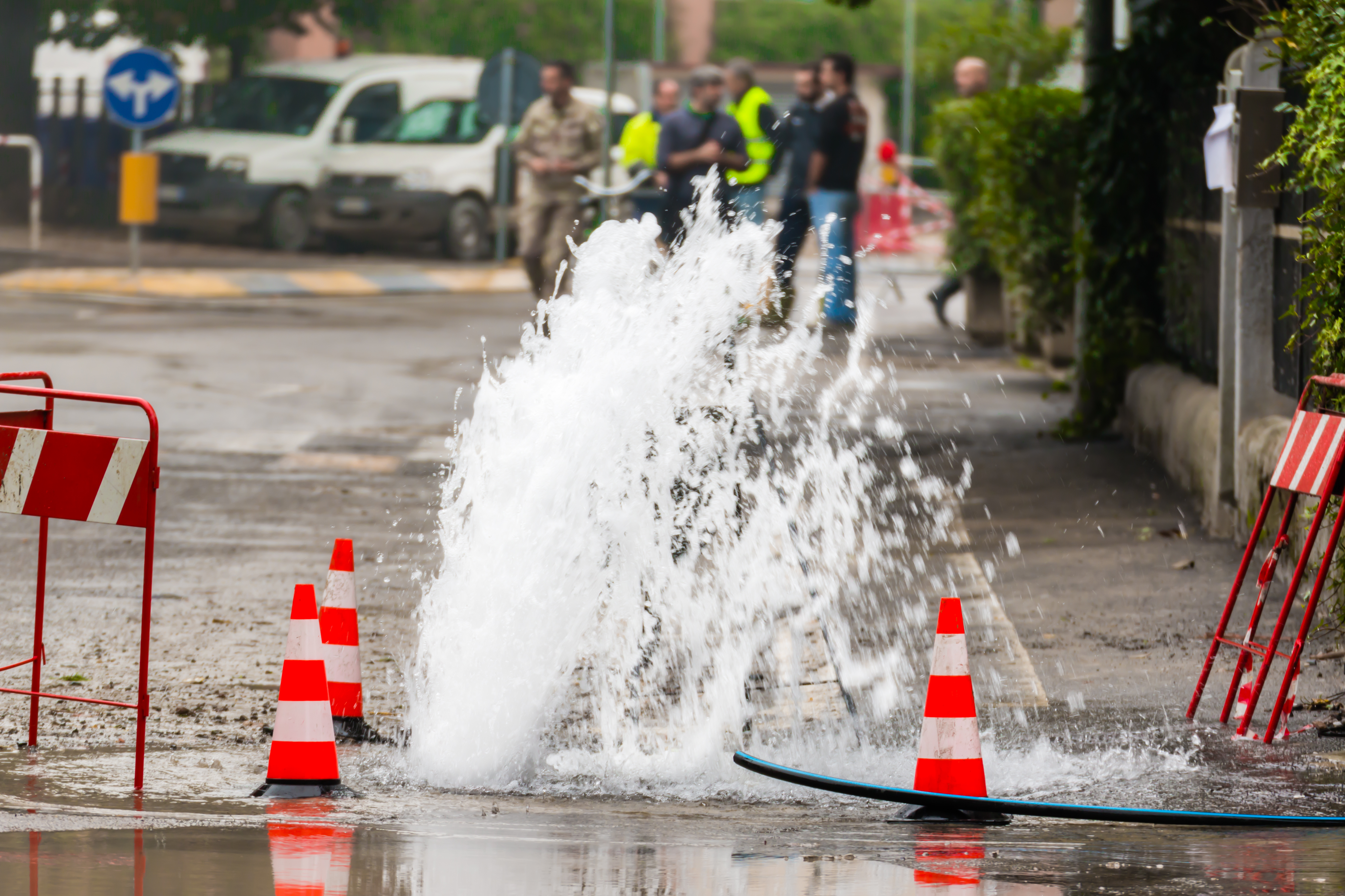 Water main break spraying into the street