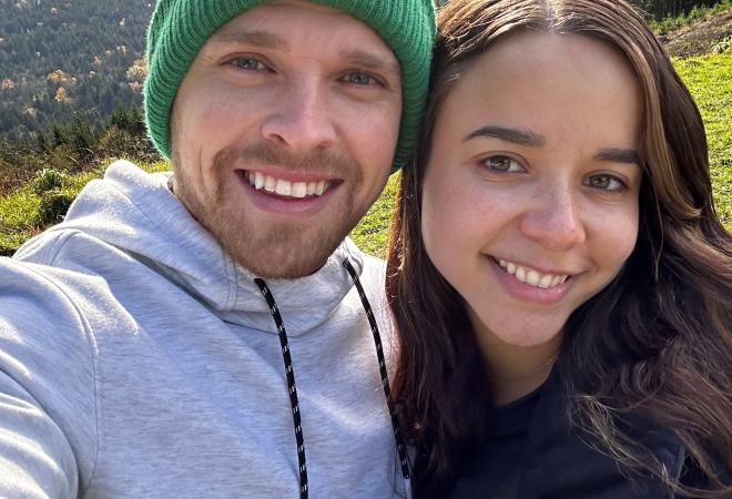 Kyle Pote outdoors with his partner