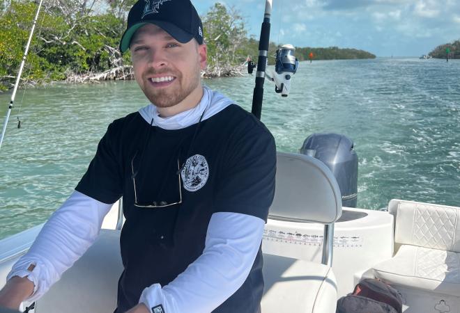 Kyle Pote driving a fishing boat
