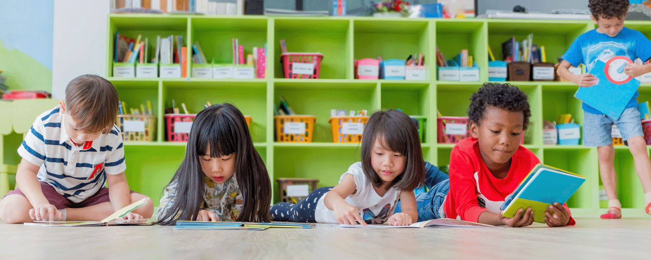 A group of diverse kindergarteners learning in class