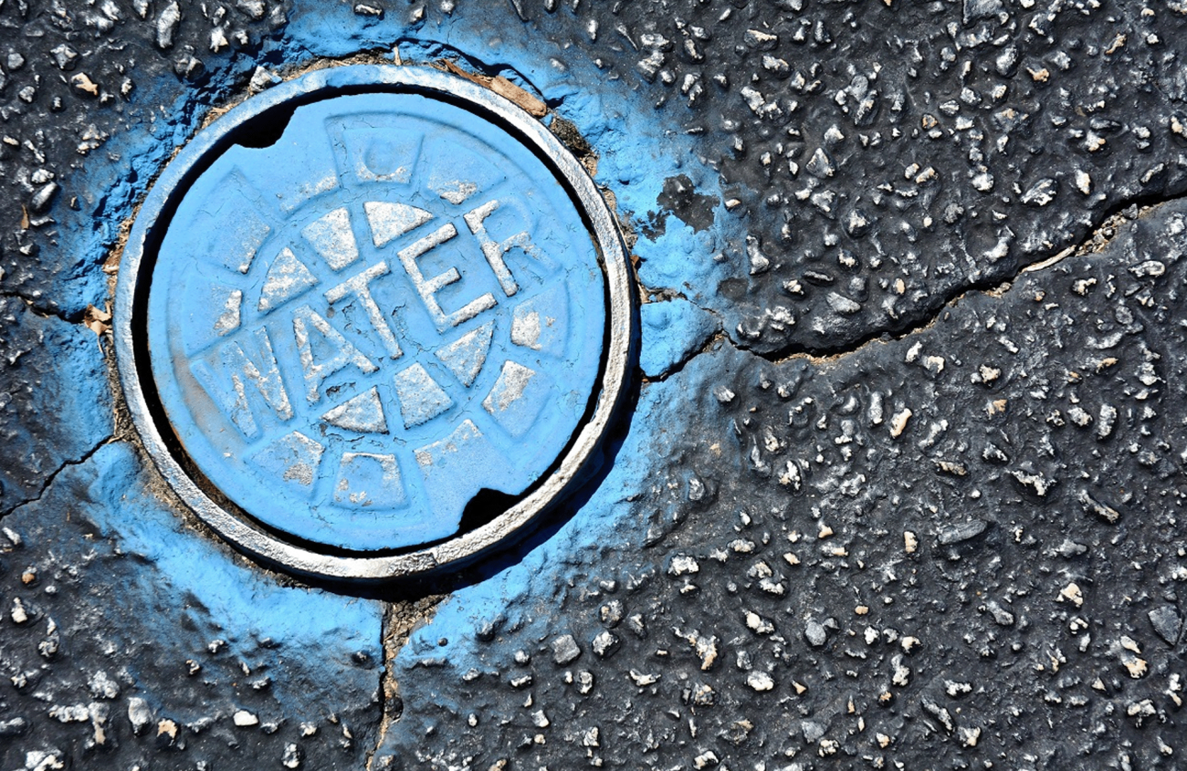 Water hole cover on pavement